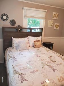 a bedroom with a bed with a comforter on it at Private Single Level Standalone House Large Lot in Charlotte