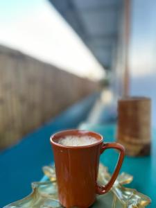 a cup of coffee sitting on a table at Bhūma in Havelock Island