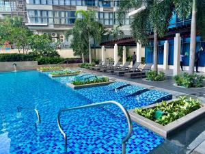a swimming pool in the middle of a building at Hotel Vibe Condo at Uptown Parksuites BGC in Manila