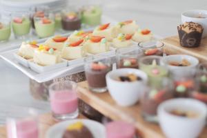 a table with several trays of cakes and desserts at Solia Zigna Kampung Batik Laweyan in Solo