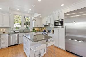 a large white kitchen with white cabinets and a counter at Casita Palo Alto - 2 Bed 2 Bath / Private Back Yard in Palo Alto