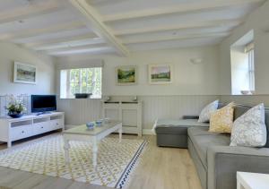 a living room with a couch and a table at Middle Barn in Leigh