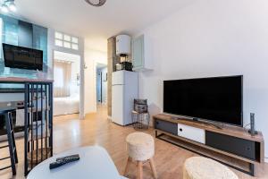 a living room with a large flat screen tv at Plaza De la Iglesia in Rincón de la Victoria