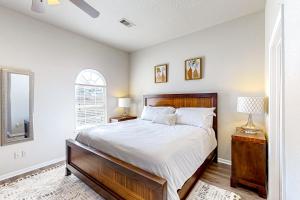 a bedroom with a large bed and a window at Arbor Glen Zen in Conroe