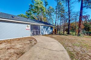 a driveway leading to a garage with a door at Arbor Glen Zen in Conroe