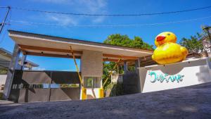 a house with a yellow bird on the side of it at Destino Beach Resort and Hotel in Batangas City