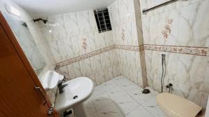 a bathroom with a sink and a toilet at Entire Place- 4BHK Apartment Uttara Near by Airport - 2KM in Dhaka
