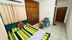 a living room with a bed and a chair at Entire Place- 4BHK Apartment Uttara Near by Airport - 2KM in Dhaka