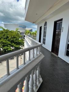 a balcony of a white building with a white railing at Landcons Hotel & Resort in Pantai Cenang