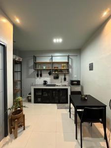 a living room with a table and a kitchen at Grey Oasis Staycation 1 Bedroom in Manila