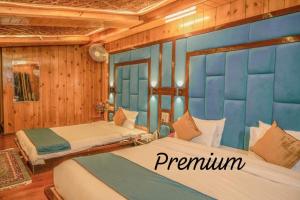 two beds in a room with wooden walls at hotel khalil in Gulmarg