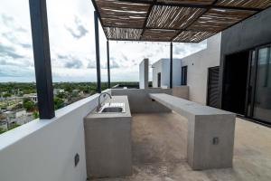 a bathroom with a sink on top of a building at The Teodoro in Tulum