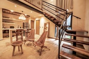 a kitchen and dining room with a staircase in a house at The Teodoro in Tulum