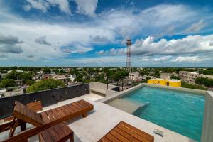 a swimming pool on the roof of a building at The Teodoro in Tulum
