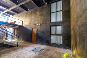 an empty room with a door and windows at The Teodoro in Tulum