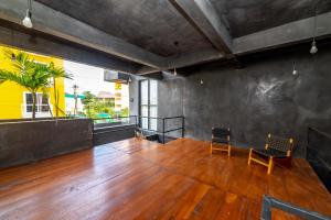 an empty room with two chairs and a wooden floor at The Teodoro in Tulum