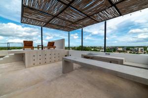 a building with two benches and a view of the city at The Teodoro in Tulum