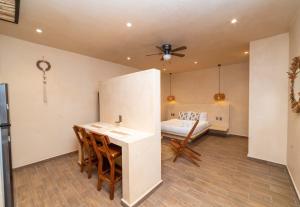 a room with a kitchen with a table and a couch at The Teodoro in Tulum