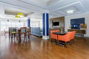 a dining room and kitchen with a table and chairs at Holiday Inn Express & Suites Jacksonville South - I-295 by IHG in Jacksonville