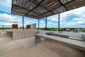 a building with benches and a view of the city at The Teodoro in Tulum