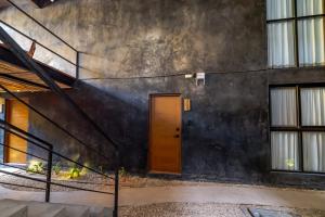 a door on the side of a building with stairs at The Teodoro in Tulum