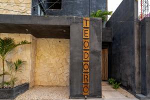 a hotel sign on the side of a building at The Teodoro in Tulum