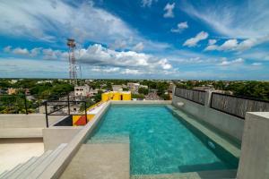 a swimming pool on the roof of a building at The Teodoro in Tulum