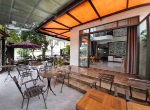 a restaurant with tables and chairs and a patio at Homestay Thule in Ho Chi Minh City