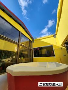a yellow and red building with a large window at 墾丁牧場Villa Kenting Pasture - Villa B&B in Kenting