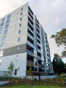 a large white building with a lot of windows at Comfort Two bedroom Apartment In Lyneham in Canberra