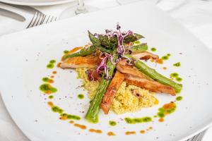 a white plate with food on a table at Hotel Rural Biniarroca - Adults Only in Sant Lluis