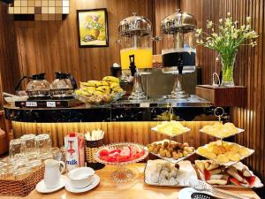 a buffet of food on a table in a restaurant at ROSA ZEN Hotel Spa in Ho Chi Minh City