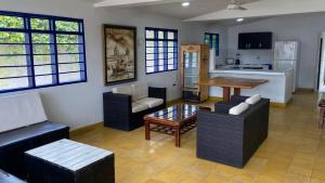 a living room with couches and a table and a kitchen at Punta Arena Beach Hostel in Playa Punta Arena