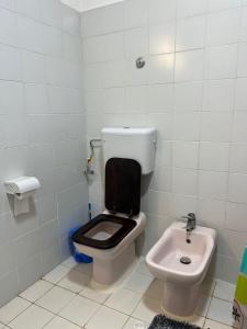 a bathroom with a toilet and a sink at BEACH FRONT VILLA in Malindi