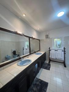 a bathroom with two sinks and a large mirror at BEACH FRONT VILLA in Malindi