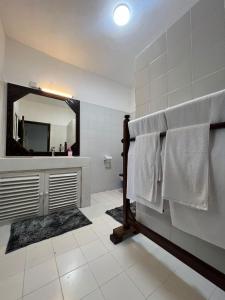 a bathroom with a sink and a mirror at BEACH FRONT VILLA in Malindi