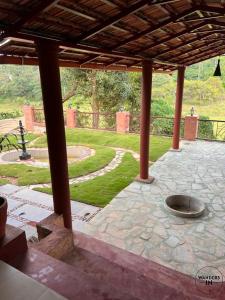 an outdoor patio with a fire pit in a park at Wanders In Coffee Stays in Madikeri
