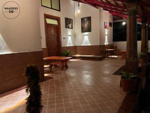 a lobby of a building with a table and benches at Wanders In Coffee Stays in Madikeri