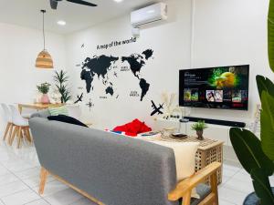 a living room with a map of the world on the wall at 6-10Pax BM 大山脚 Alma SingleStoreySemi-D Near AEON Mall Pool Netflix Wifi in Bukit Mertajam