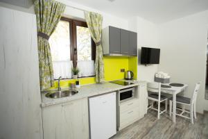 a small kitchen with a sink and a table at Arima city in Shumen