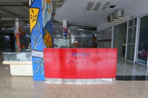 a store with a red sign in the middle of a building at Capital O 93490 Yubi Room Patraland in Bekasi