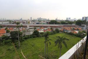 a view of a city with palm trees and buildings at Capital O 93490 Yubi Room Patraland in Bekasi