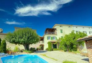 a house with a swimming pool in front of it at Villa Angiolina in Višnjan