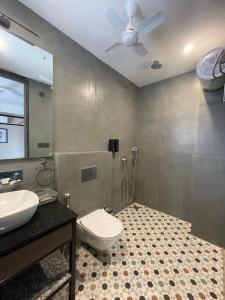 a bathroom with a toilet and a sink at The Deck in Jaipur