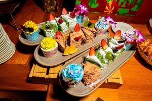 a table with three trays of desserts on them at Summer Bay Beach Club & Cabins in Sihanoukville