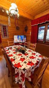 a dining room table with a red and white table cloth at Góralska Chata & Spa in Muszyna