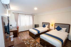 Letto o letti in una camera di Kathmandu Business Hotel