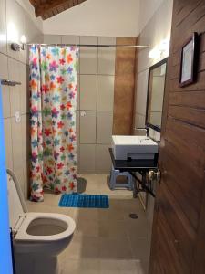 a bathroom with a shower and a toilet and a sink at Tranquility In The Himalayas in Shimla