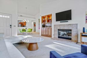 a living room with a couch and a fireplace at Idyll in the Desert - Immaculate Palm Desert Getaway in Palm Desert