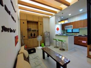 a kitchen with a couch and a table in a room at 1986 Travel Hall in Tainan